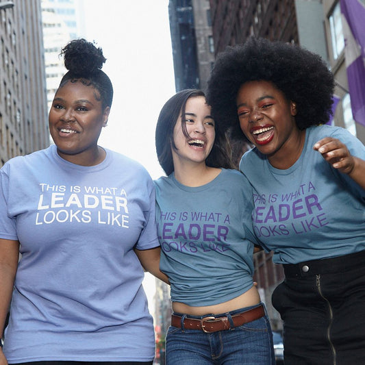 Three women laughing wearing Sadie Nash t-shirts